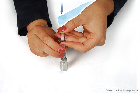 Pushing the syringe plunger